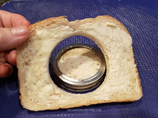 A hole has been made in the slice of sourdough bread.