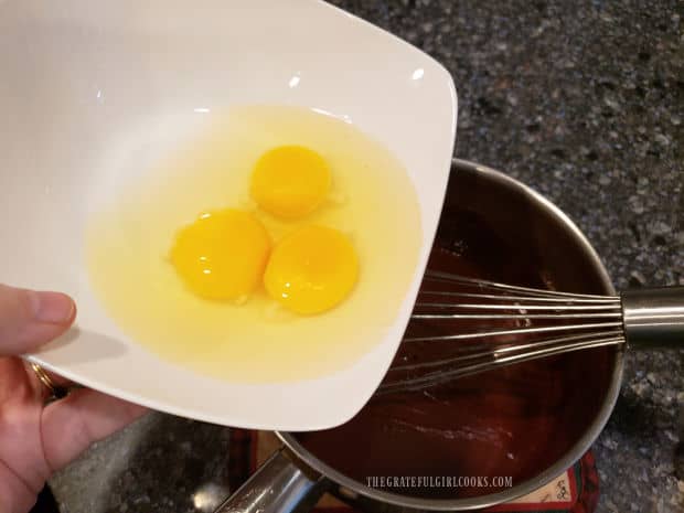 Eggs are whisked into the flourless chocolate cake mixture.