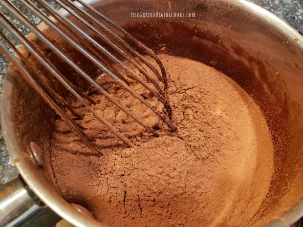 Cocoa powder is sifted, then whisked into the chocolate cake batter.