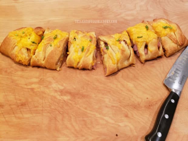 Six portions of ham 'n cheese crescent bites are cut for serving.