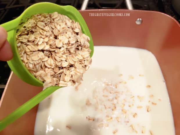 Oats are added to heated milk in saucepan.