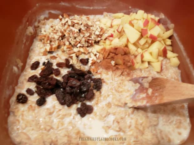 Maple syrup, raisins, nuts, apple and cinnamon are added to oatmeal.