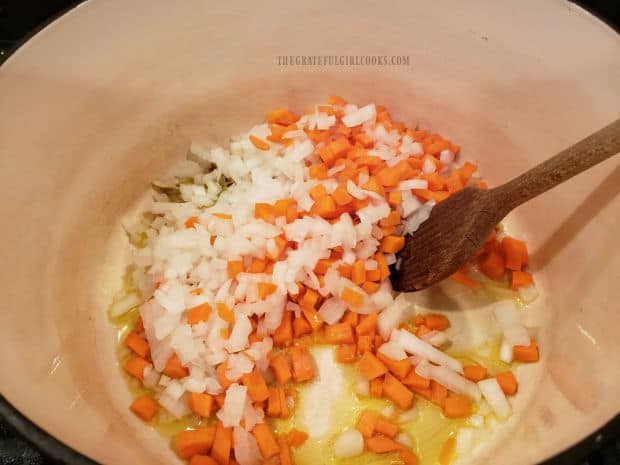 Carrots, celery and onion are cooked in olive oil in a large soup pot.