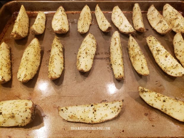 The Parmesan garlic potato wedges are baked in a single layer, skin side down.