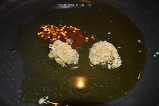 Garlic and red pepper flakes cook in hot oil before adding remaining ingredients.