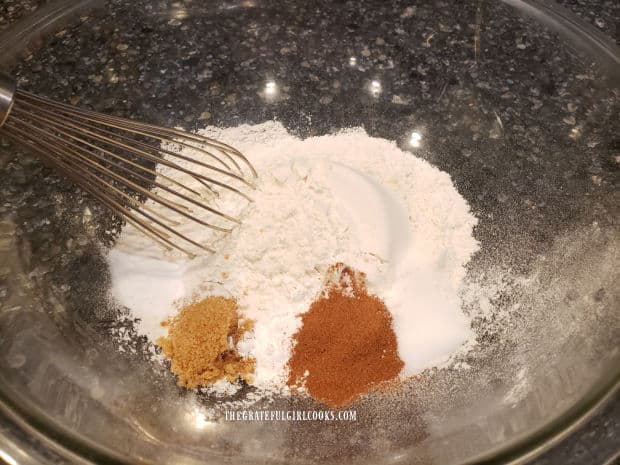 Flour sugar and spices are combined for the waffle batter.