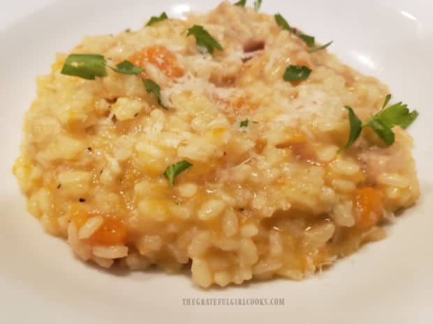 Butternut Squash Risotto with Chicken, garnished with parsley, served in a white bowl.