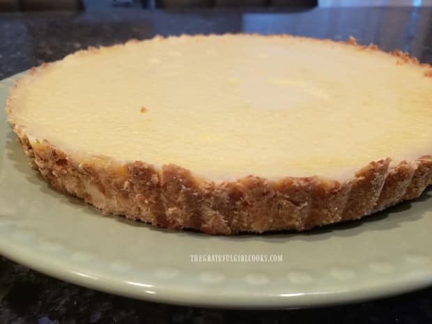 When ready to serve, the chilled lemon cream cheese tart is removed from the pan.