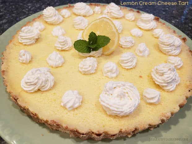 This Lemon Cream Cheese Tart is a bit tangy, a bit sweet, and tastes fantastic! A creamy lemon filling is baked on a shortbread-style crust.