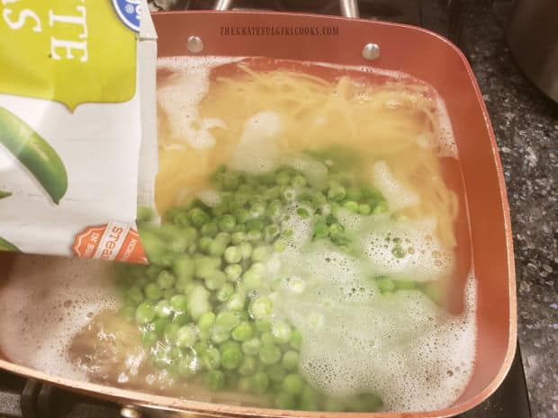 Frozen peas are added directly into the boiling pasta and water.