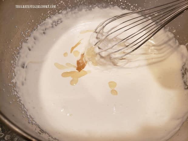 Gelatin mixture is slowly added to whipped cream, as it is being beaten.