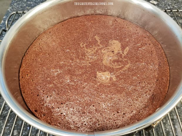 After baking, the mint brownie pie chocolate layer cools in the pan on a wire rack.