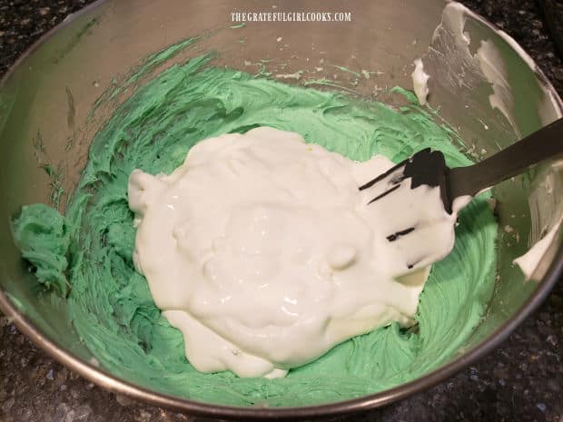 Whipped topping is gently folded into the green tinted cream cheese filling.