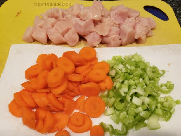 Chicken breast, carrots and celery are cut and ready to stir-fry.