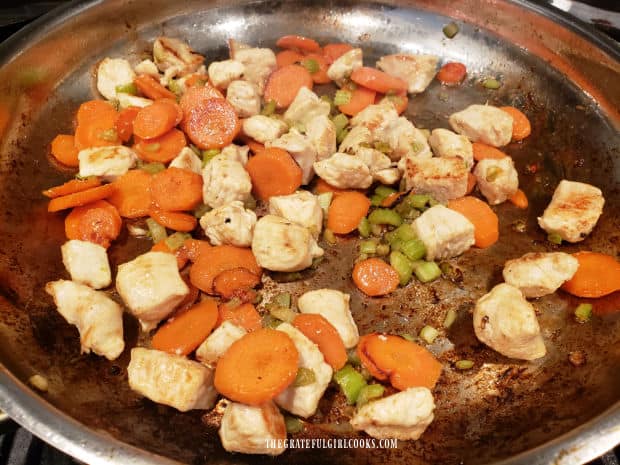 After stir-frying, the chicken is lightly browned and veggies are tender.