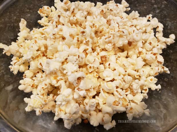 Plain popped popcorn in a bowl, ready for buttery seasoning sauce.