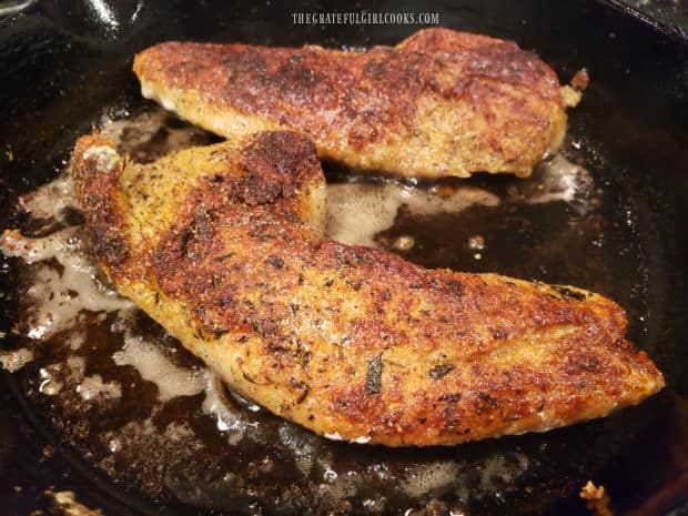 The skillet grilled rockfish fillets are flipped over halfway through cooking time.