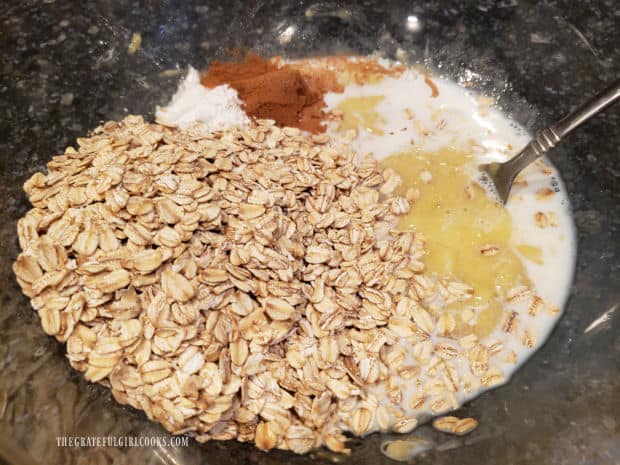 Old-fashioned oats, cinnamon, milk, salt and baking powder are added to banana mixture.