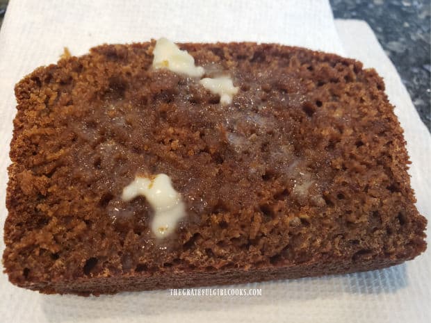 One warm slice of baked brown bread, spread with melting butter.