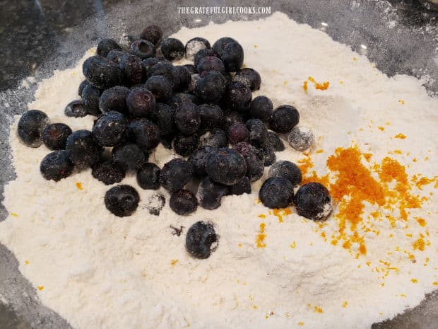 Blueberries (fresh or frozen) and orange zest are added to dry ingredients.
