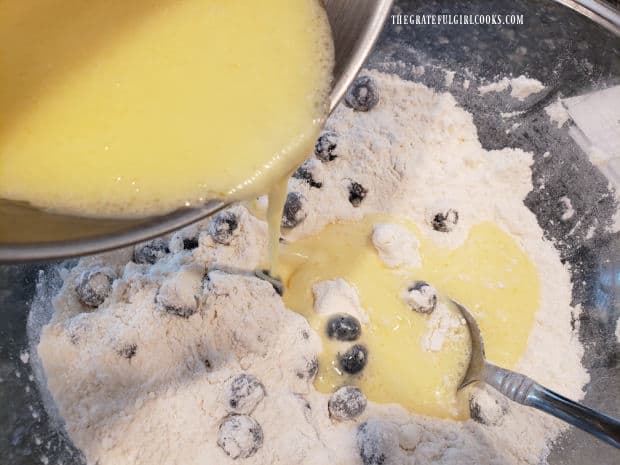 Wet ingredients are added to the blueberry breakfast loaf batter.