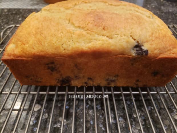 A side view of the blueberry breakfast loaf, out of the pan and on wire rack.