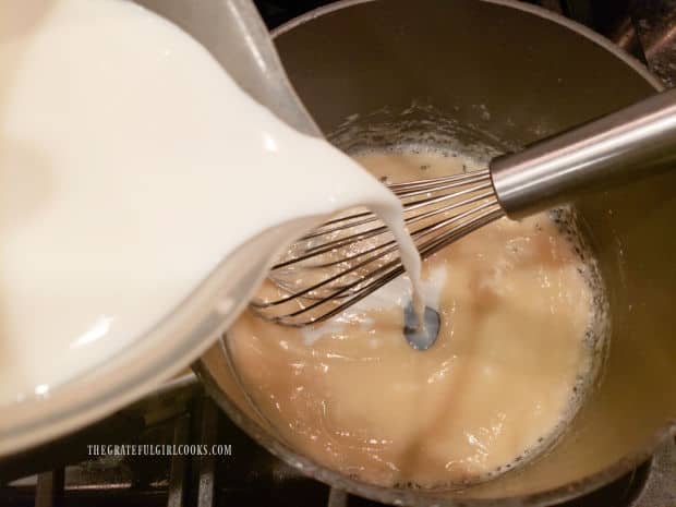 Milk is slowly added to the bubbly flour mixture, and whisked until fully combined.