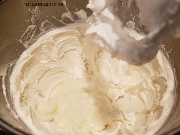 Cooled and thickened milk mixture is added to Grandma's fluffy white frosting mixture and combined.