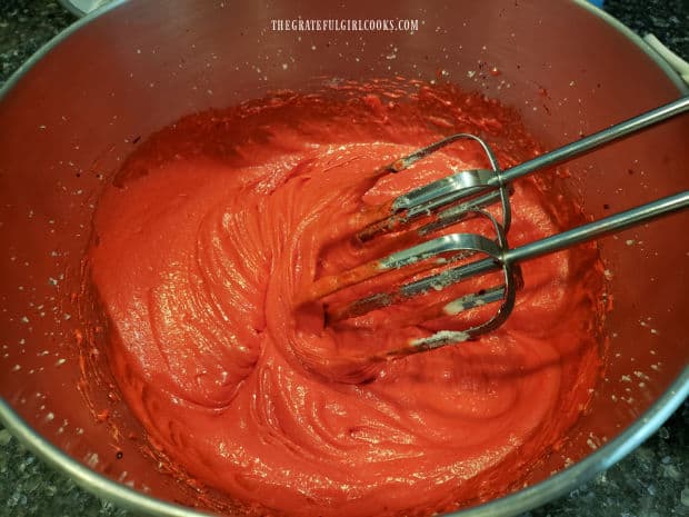 Red food coloring and eggs are added and mixed into the cake batter.