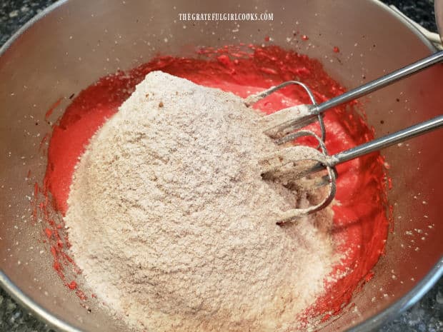 Dry ingredients (with flour and cocoa, etc.) are added to the cake batter.