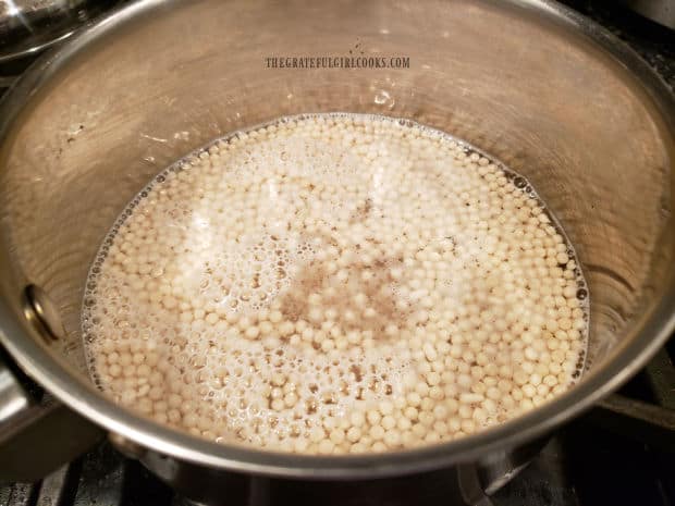 Pearl couscous is cooked in boiling water for 8-10 minutes until liquid is absorbed.