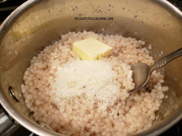 Butter and Parmesan cheese are stirred into hot cooked pearl couscous.