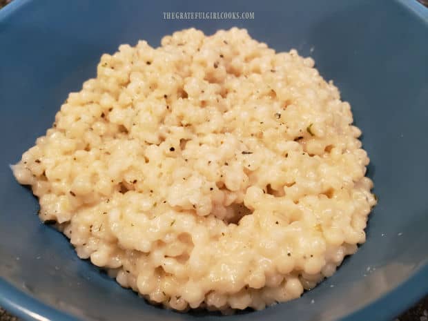 Once done, the creamy Italian Parmesan Pearl Couscous is transferred to a serving bowl.