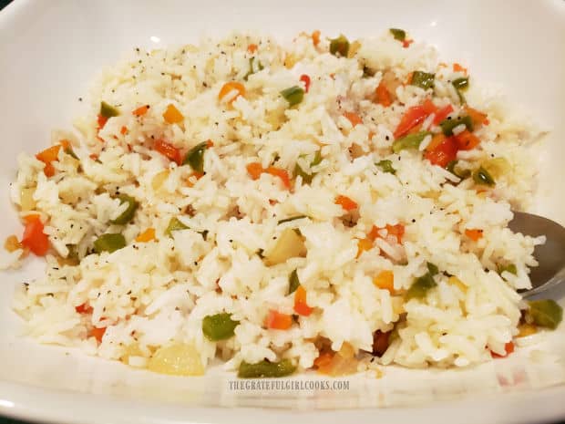 Colorful and delicious rainbow rice is served hot in a large white bowl.