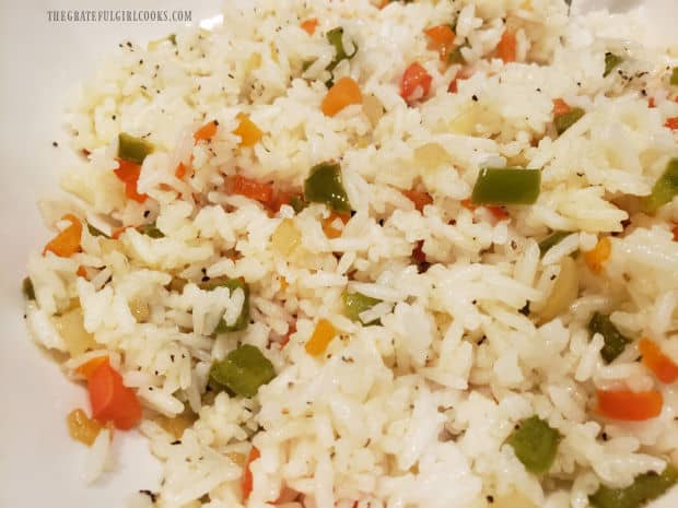 Rainbow rice is mixed together and then seasoned with salt, pepper, and garlic powder.