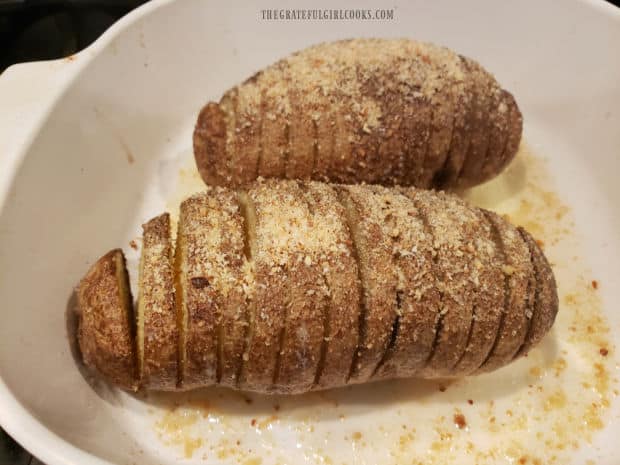 Halfway through baking time, more butter and bread crumbs are added to roasted Hasselback potatoes.