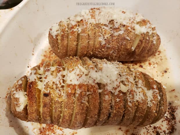 Grated Parmesan cheese is added to top of potatoes, and then they finish baking.