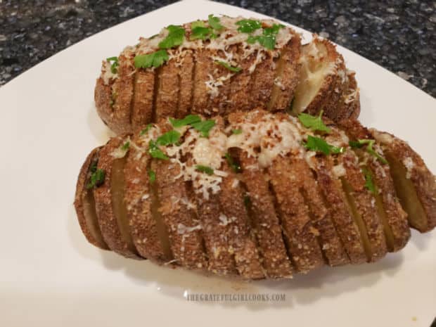 Roasted Hasselback Potatoes, served on a white plate, are a perfect side dish!