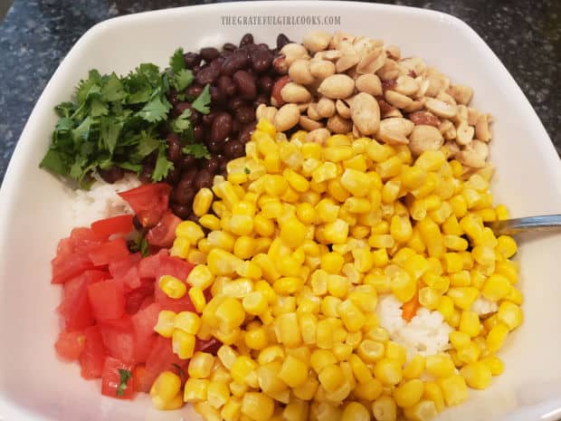 Corn, black beans, tomatoes, cilantro and salted peanuts are added to the Southwestern rice salad.