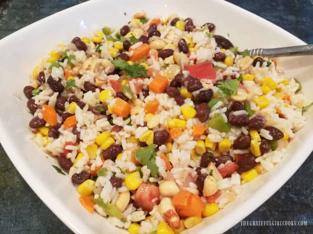 After chilling in the refrigerator, the Southwestern Rice Salad is served in a white bowl.