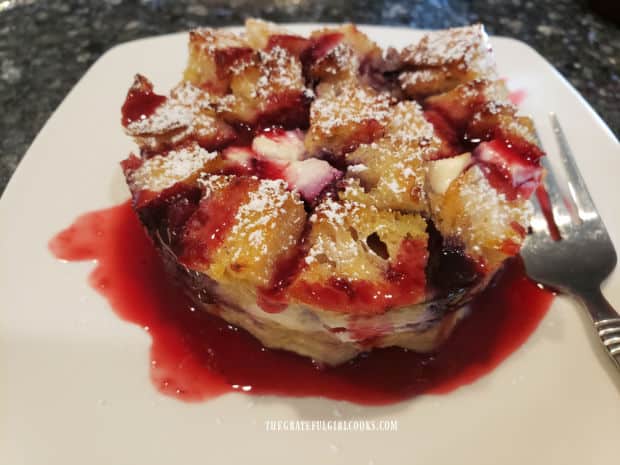 Berry-flavored pancake syrup and powdered sugar are added to triple berry French toast cups for serving.