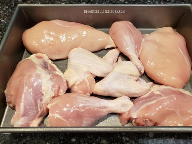 Chicken pieces are placed in a 13"x9" baking pan in a single layer.