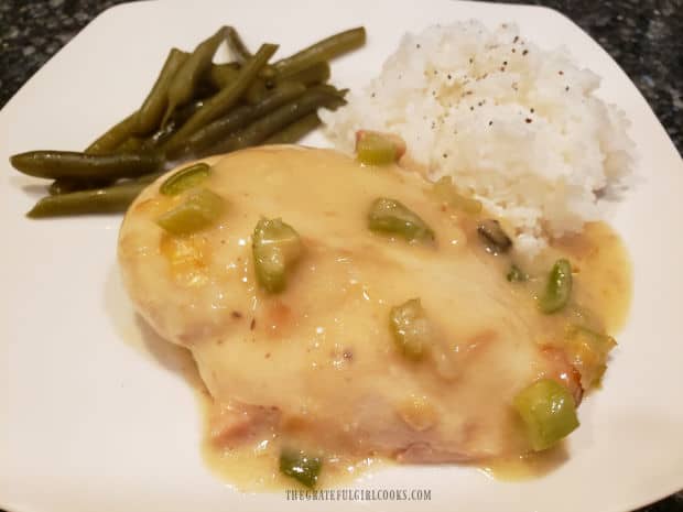 Rice and green beans are served alongside the yum yum chicken, on a white plate.