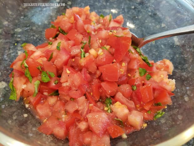 After stirring, the tomatoes and other ingredients sit undisturbed for at least an hour.