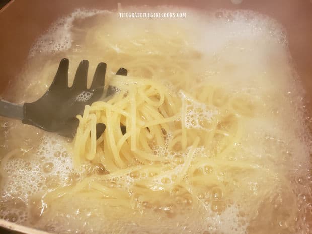 Spaghetti noodles (or angel hair pasta) is cooked in boiling water