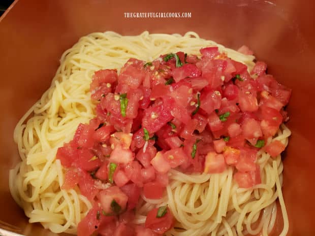 The easy tomato basil pasta ingredients are combined and tossed until fully integrated.