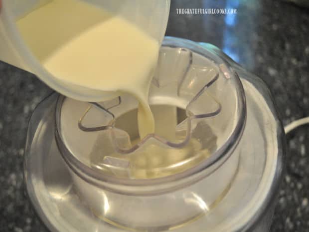 The blended ingredients for the vanilla ice cream are poured into the cannister before freezing.
