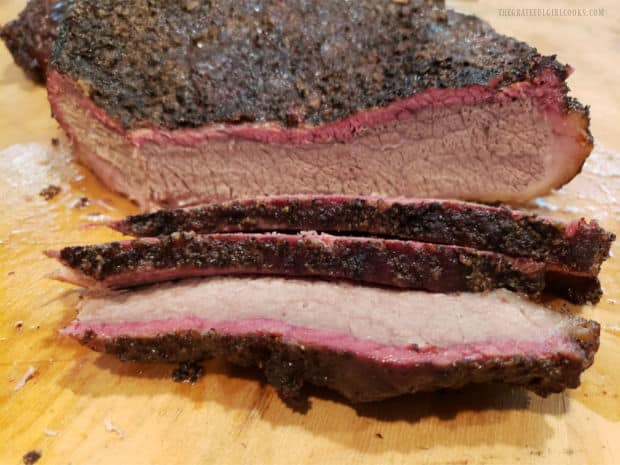 Slices of smoked brisket of beef on a cutting board, ready to enjoy.