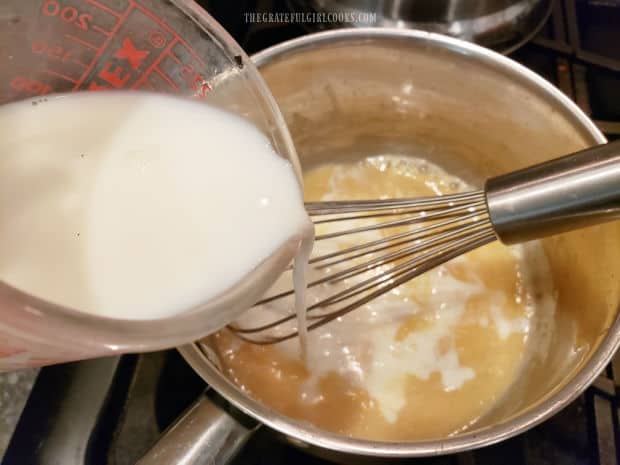 Milk is whisked into the flour/butter sauce, and cooked until slightly thickened and smooth.