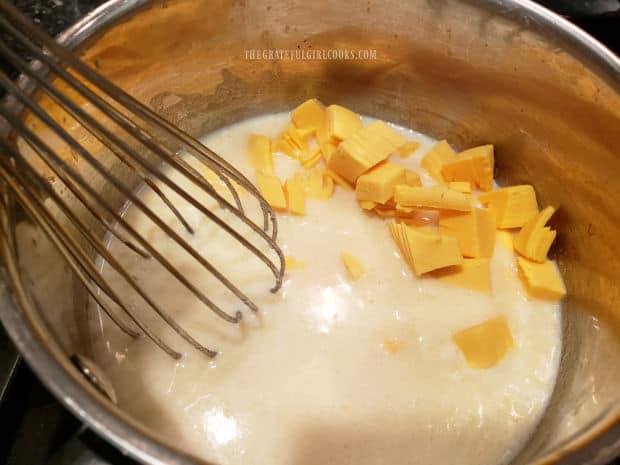 American or Velveeta cheese is added to the creamy sauce mixture and cooked until melted.